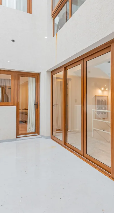 Patio con puertas y ventanas de madera y ventanal